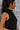Side view of model wearing The Midnight Magic Feather Dress features black fabric, a mock neckline, a sleeveless a-line silhouette, and a feather-trimmed hemline.