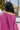 Back detail view of model waring The Blake Cropped Sweatshirt In Purple features knit fabric with a soft fleece interior, a round neckline, long batwing sleeves, and a wide cropped fit