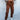 Front view of model wearing Running Up That Hill Joggers features a brown colored nylon material, a high-rise fit, a thick elastic waist with an adjustable tie, side pockets, and a jogger fit.