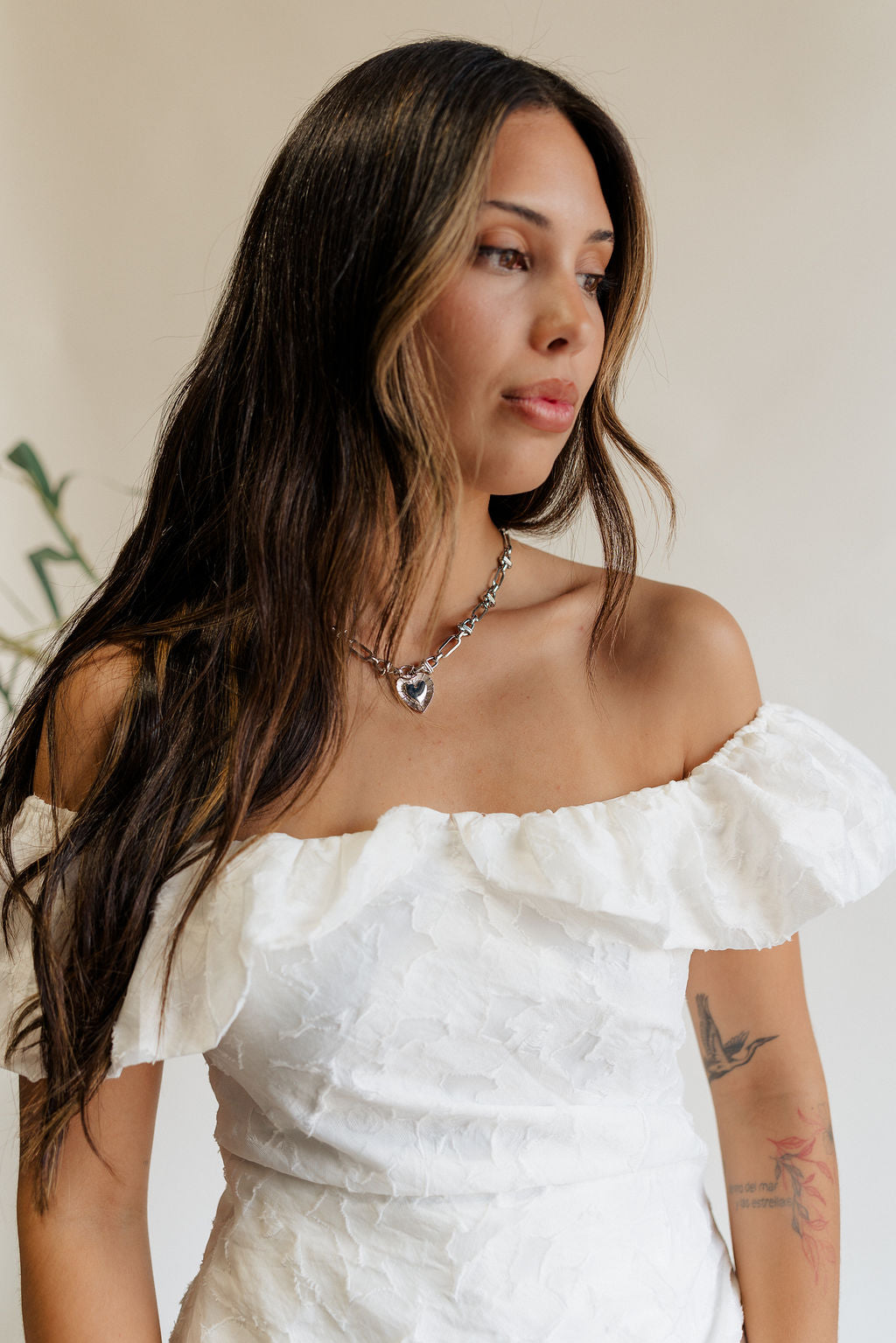 Front view of female model wearing the Isla Silver Heart Chain Necklace.