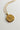 Close-up image of the Scorpio Zodiac Gold Coin Necklace that has a scorpion on the coin. Shown against white background.