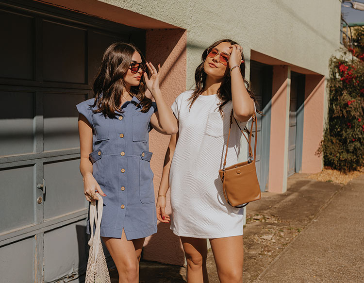image of 2 models in a blue button up collared dress and another model in a white knit mini dress with a front pocket