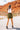 Back view of the Livin' The Dream Shorts that features an olive green colored material, a high-rise fit, an elastic waist, a belt detail, side pockets, and a flowy fit.
