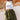 Frontal view of the Livin' The Dream Shorts that features an olive green colored material, a high-rise fit, an elastic waist, a belt detail, side pockets, and a flowy fit.