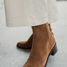 Front angle view of female model wearing the Linny H2O Boot in Brown Suede H2O which features cognac suede upper fabric, round toe, tall shaft, block heel and pull on tab