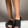 Close front view of model wearing the Newport Platform Sandals that have thick black platform soles and a thick mesh strap.