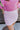 Close front view of model wearing the Shine On Sequin Skirt in Pink, which features light pink fabric with a sequined overlay, ruching on the front, and an elastic waist.
