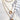 Close up image of The Golden Hour Necklace, that features three gold chains of varying lengths, a gold open circle pendant, and a rhinestone open circle pendant.
