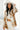 Front view of model wearing the Warm Wishes Plaid Shacket that has brown, black and cream plaid with a cream faux-fur lining, a button-up front, a collar, two front pocket, and long sleeves. Worn unbuttoned over white top.