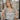 Front view of model wearing the All That Shines Top that has nude mesh fabric with silver sequin details, a cropped waist, a side zipper closure, a surplice neckline, and short sleeves