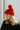 Close side view of model wearing the Fireside Beanie in Pink that has pink knit fabric, a folded cuff with a brown "C.C" patch, and a pink pompom.
