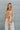 Front view of model wearing the Turn Back Time Top that has cream sheer fabric with mustard and brown pattern details, fabric covered buttons, a collared neckline, and long balloon sleeves with smocked wrists