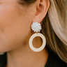 Close side view of model wearing the Lots Of Love Earrings that feature clusters of white beads and matte gold circles.