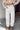 Front view of model wearing the Hudson Corduroy Cargo Pants that have off white corduroy fabric, light brown stitching, side front and back pockets, belt loops and wide legs