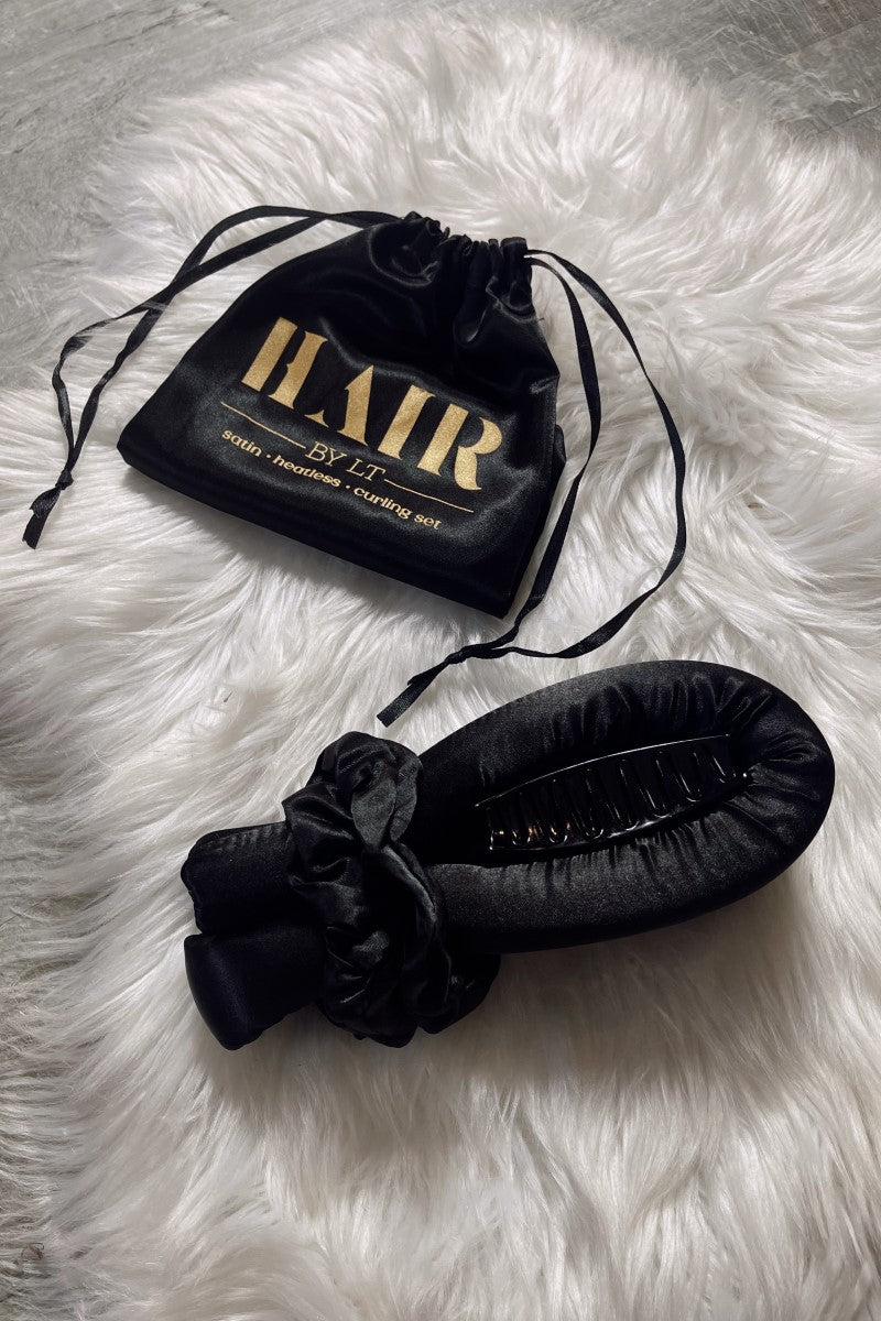 Image shows the Satin Curless Hair Set black satin bag which reads "Hair By LT. Satin Heatless Curling set." in gold. Contents of bag are next to it.