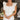 Front view of model wearing the Modern Day Ruffle Romper which features cream fabric, pockets on each side, front zipper closure, square neckline, ruffle straps, elastic band in the back and sleeveless.