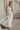 Full body view of model wearing the Chloe Ivory Mesh Lined Maxi Dress which features white mesh fabric, white lining, maxi length, a high neckline, and short sleeves.
