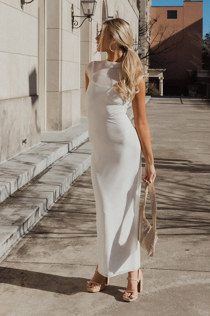 Full body view of model wearing the Chloe Ivory Mesh Lined Maxi Dress which features white mesh fabric, white lining, maxi length, a high neckline, and short sleeves.