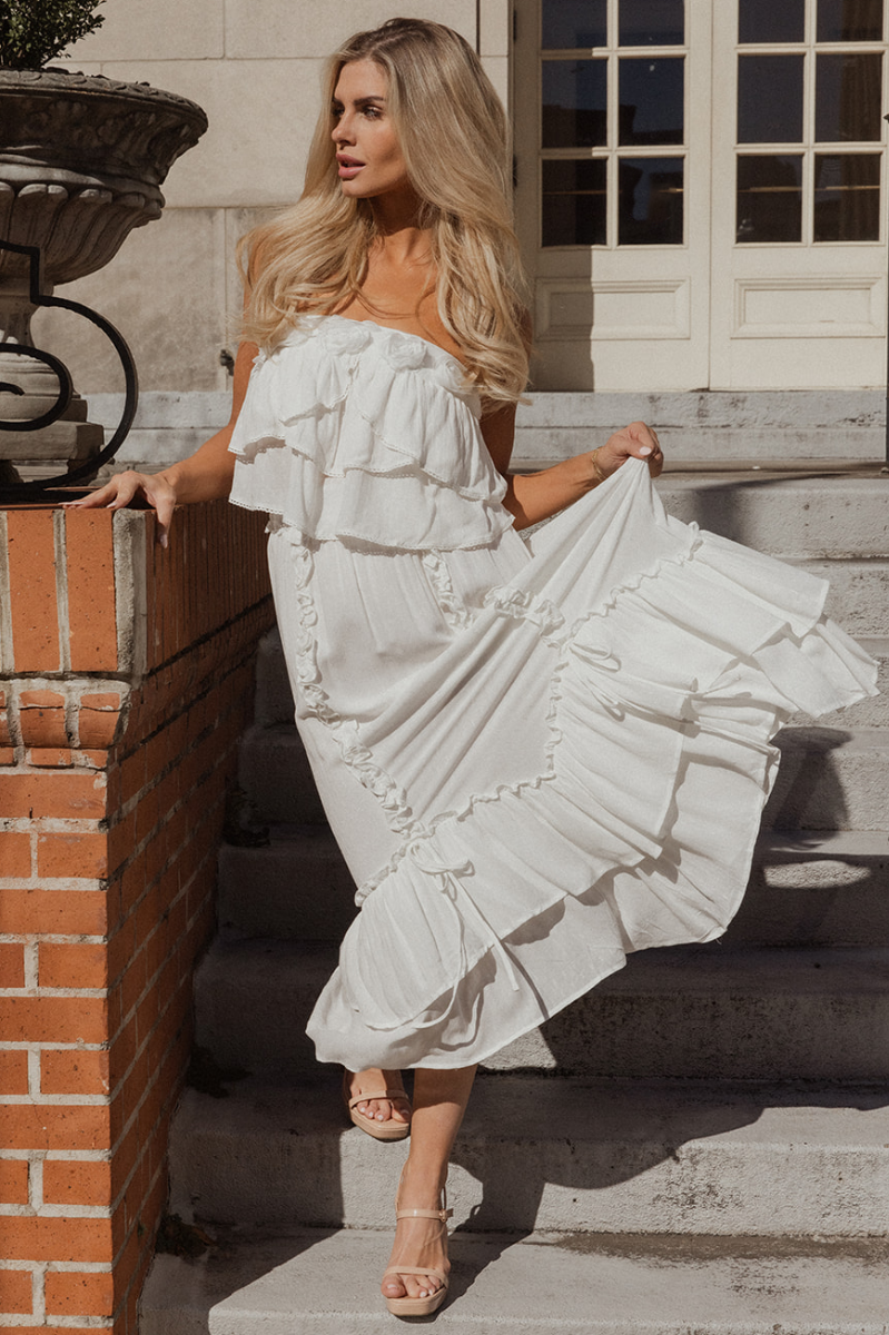 Full body view of model wearing the Isla Off White Ruffle Midi Skirt which features off white textured knit fabric, tiered design, tie details, ruffle details, midi length, white lining and elastic waistband.