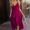 Full body view of model wearing the Valerie Magenta Sleeveless Ruffle Midi Dress which features magenta knit fabric, a ruffle hem, a front slit, a v neckline, adjustable spaghetti straps, and a monochromatic back zipper with a hook closure.