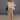 Full body view of model wearing the Ready or Not Cargo Pants in Brown that have light brown denim fabric, cargo pockets on each side, a front zipper with a button closure, two front pockets, belt loops and wide pant legs