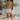 Full body front view of model wearing the Hard To Get Pleather Skirt that has taupe pleather fabric, mini length, two front pockets, two back pockets, a front zipper with a button closure and belt loops
