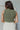 Back view of model wearing the I Go Back Tank in Olive which features olive green chenille knit fabric, high neckline and sleeveless.