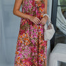 Front view of model wearing the Everything To Me Floral Dress which features a brown, orange, pink, green and white floral print, midi length, a scooped neckline, and adjustable straps.