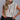 Front view of model wearing the Life In Color Sweater Vest that has cream knit fabric colorful stripe pattern, a thick hem, a round neck and a sleeveless design. Worn tucked in.
