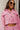Close-up front view of model wearing the Live Your Best Life Cropped Blazer, which has a pink tweed material, a collar neck, a cuffed long sleeve with a button detail, a button-up front, two front pockets, and a cropped fit