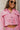 Close-up front view of model wearing the Live Your Best Life Cropped Blazer, which has a pink tweed material, a collar neck, a cuffed long sleeve with a button detail, a button-up front, two front pockets, and a cropped fit