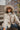 Frontal view of the Weekend Plans Jacket that features a taupe colored material, a grey and ivory plaid, a collar neck, a long cuffed sleeve, and a button-up front