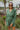 Frontal view of the More Than Enough Romper that features a green corduroy material, a collar neck, a surplice front, a long sleeve with a button, a front zipper, pockets, and pleating on the legs.