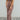 Front view of model wearing The Work It Out Tie Pant which features soft mocha-colored ribbed fabric, an elastic drawstring waist, and wide legs with side slits.