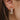 Close side view of model wearing the Fairytale Ending Hoop Earring, which features small open gold hoops with clear rhinestone flowers.