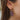 Close side view of model wearing the Party Time Earrings, which feature gold teardrops filled with multi-colored glitter.