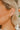 The Always A Gem Earring is a gold hoop style earring, featuring multi-colored stones and pearl beads through out.