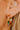 The Always A Gem Earring is a gold hoop style earring, featuring multi-colored stones and pearl beads through out.