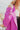 Side view of the Give Me A Beat Cropped Blazer features a purple colored material, a collar and lapel, a front button closure, and long sleeves.