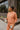 Frontal view of model wearing the Setting The Vibe Top, which has an orange terry cloth ribbed material, a round neck, long cuffed sleeves, a thick bottom hem, and side slits. Worn with matching pants