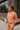 Frontal view of model wearing the Setting The Vibe Top, which has an orange terry cloth ribbed material, a round neck, long cuffed sleeves, a thick bottom hem, and side slits. Worn with matching pants