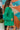 Side view of the Blakely Blazer In Green that features a green material, a collar and lapel, a two button front closure, a long sleeve, shoulder pads, two front pockets, and a back slit.