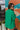 Back view of the Blakely Blazer In Green that features a green material, a collar and lapel, a two button front closure, a long sleeve, shoulder pads, two front pockets, and a back slit.