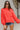 Frontal view of the Walk The Line Sweater that features a red knit material, a round neck, a long sleeve, a front pocket, a high-low design, and a flowy fit.
