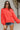 Frontal view of the Walk The Line Sweater that features a red knit material, a round neck, a long sleeve, a front pocket, a high-low design, and a flowy fit.