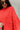 Frontal view of the Walk The Line Sweater that features a red knit material, a round neck, a long sleeve, a front pocket, a high-low design, and a flowy fit.