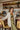 Frontal view of the happy Hour Blazer that features an ivory material, a collar and lapel, a two button front closure, a long sleeve, shoulder pads, two front pockets, and a back slit.