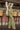 Frontal view of the First Class Pants that features a green colored material, a high rise fit, a clasp and zipper front closure, a cross button detail, belt loops, front pockets, a pleating at the waist, two back faux pockets, and a wide leg fit.