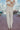 Back view of the Let's Chat Pants that features a beige colored material, a high-rise waist, a sweetheart cut waist hemline, a seam down the front legs, a wide leg fit, and a back zipper closure.