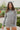 Frontal view of the Moment In Time Top that features a heather grey knit material, a high neckline, long cuffed sleeves, and a thick bottom hem.